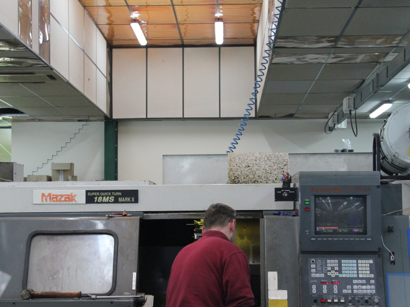 Machinist operating a Mazak Super Quick Turn CNC lathe at the Makefast factory